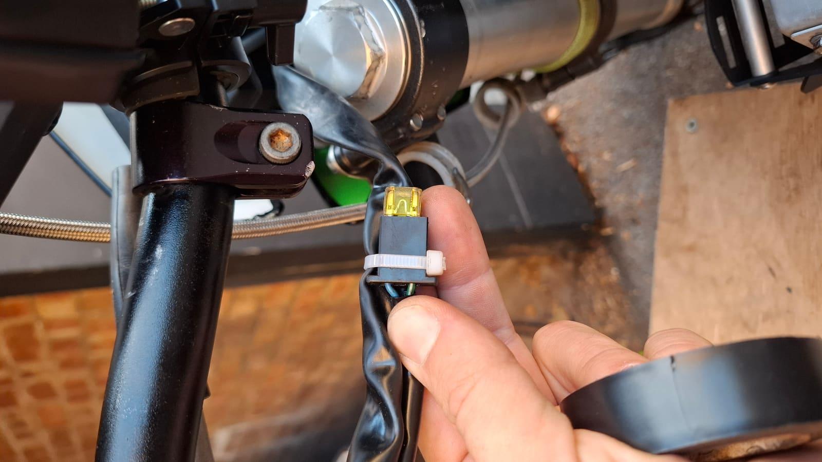 Mini blade fuse with the legs bent, jumping the clutch switch connector at the lever
